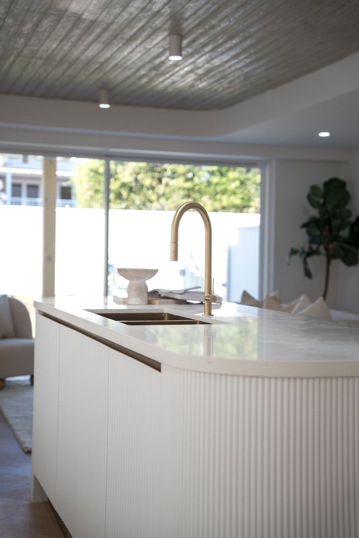Fluted stone island bench and brass tapware, Little Bay