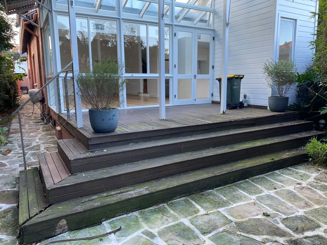 The old timber deck and steps before demolition, outside the conservatory doors