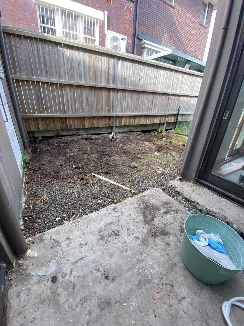 The bare side courtyard before the deck