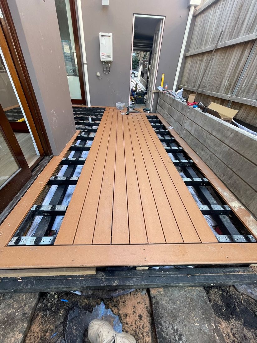 The deck frame and the first composite boards set out down the courtyard