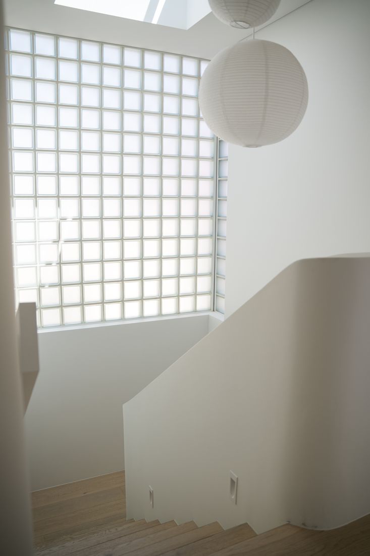 Glass-block wall lighting a white stairwell, Bondi Beach