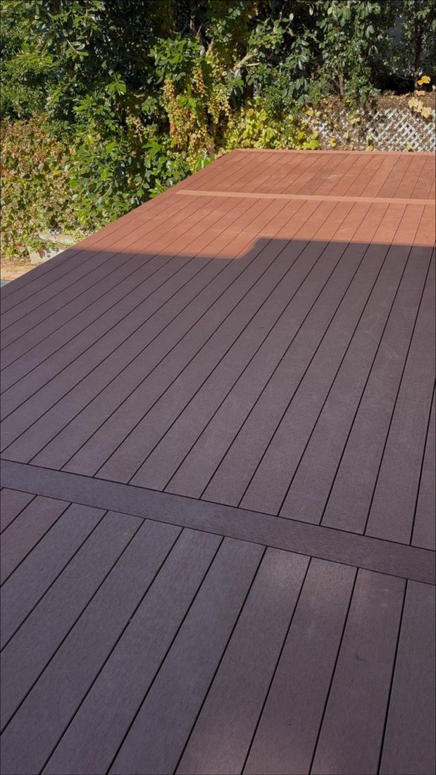 The finished deck boards with a border band, in afternoon light