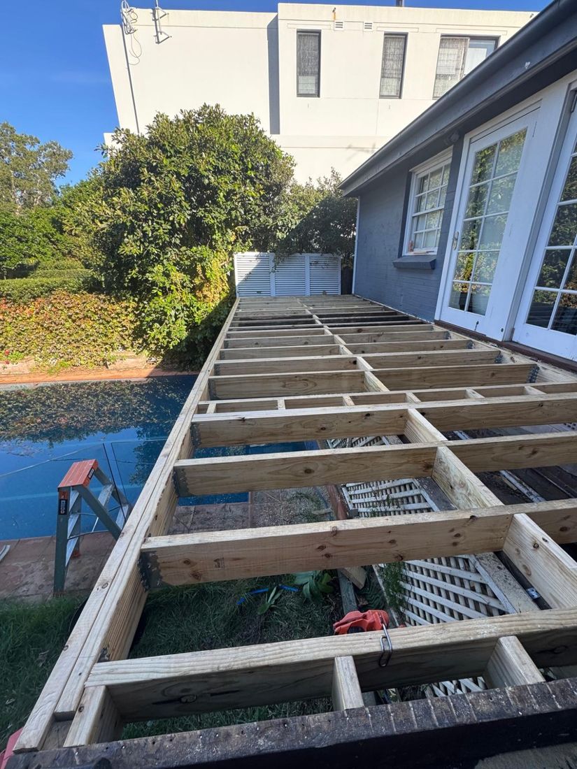 The timber deck frame beside the pool, ready for boards