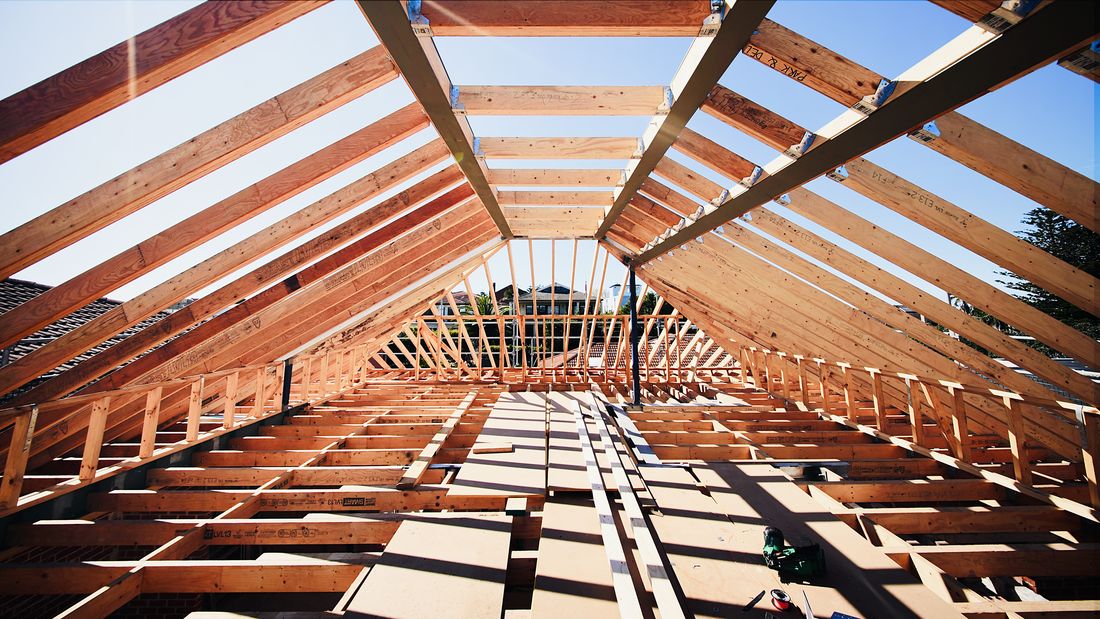 The attic space under the timber rafters of the new roof