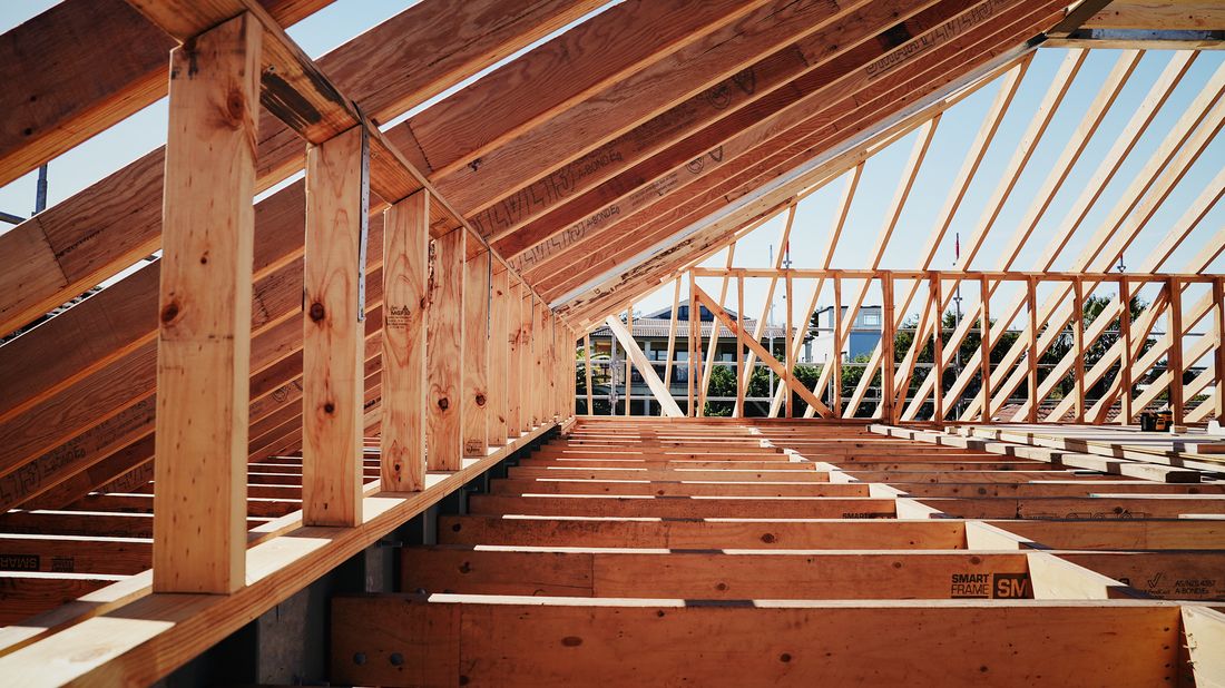 Timber wall frames and ceiling joists carrying the roof construction