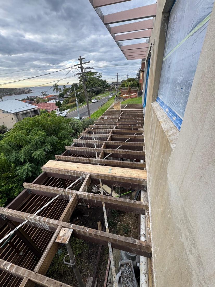 The deck frame with the old boards removed, looking out over Malabar