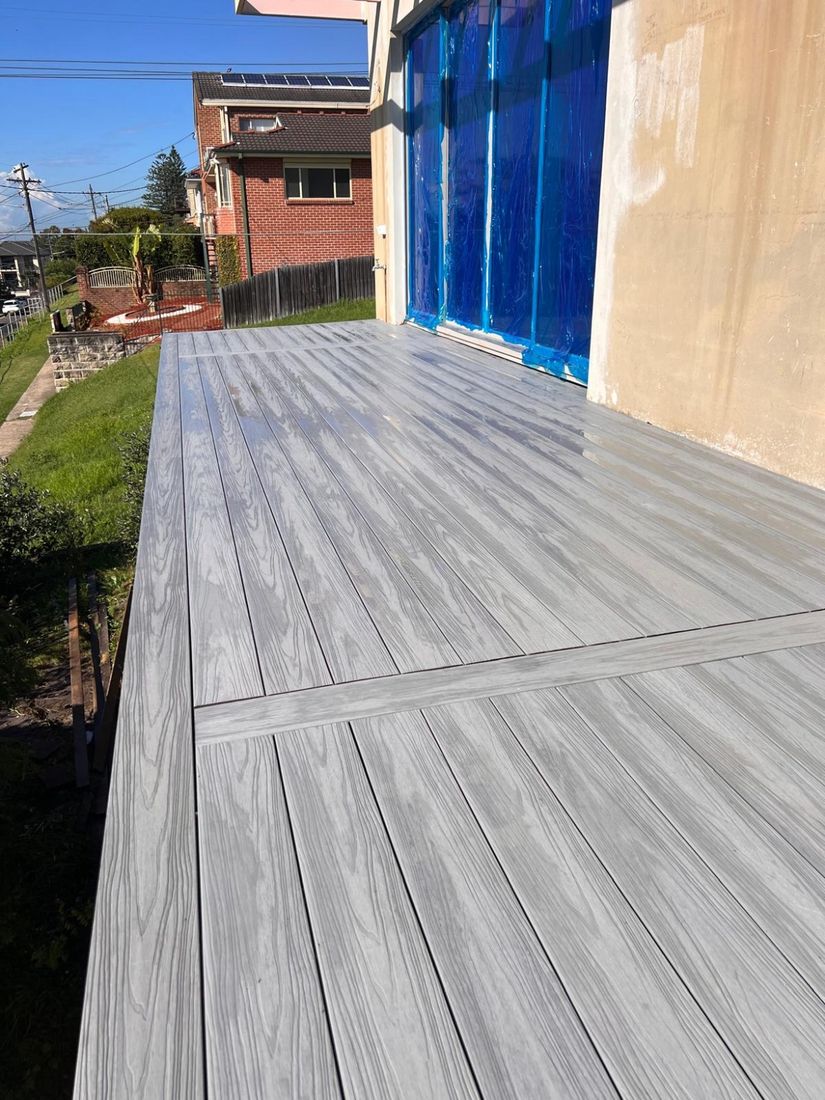 The completed grey Ekodeck deck along the side of the house