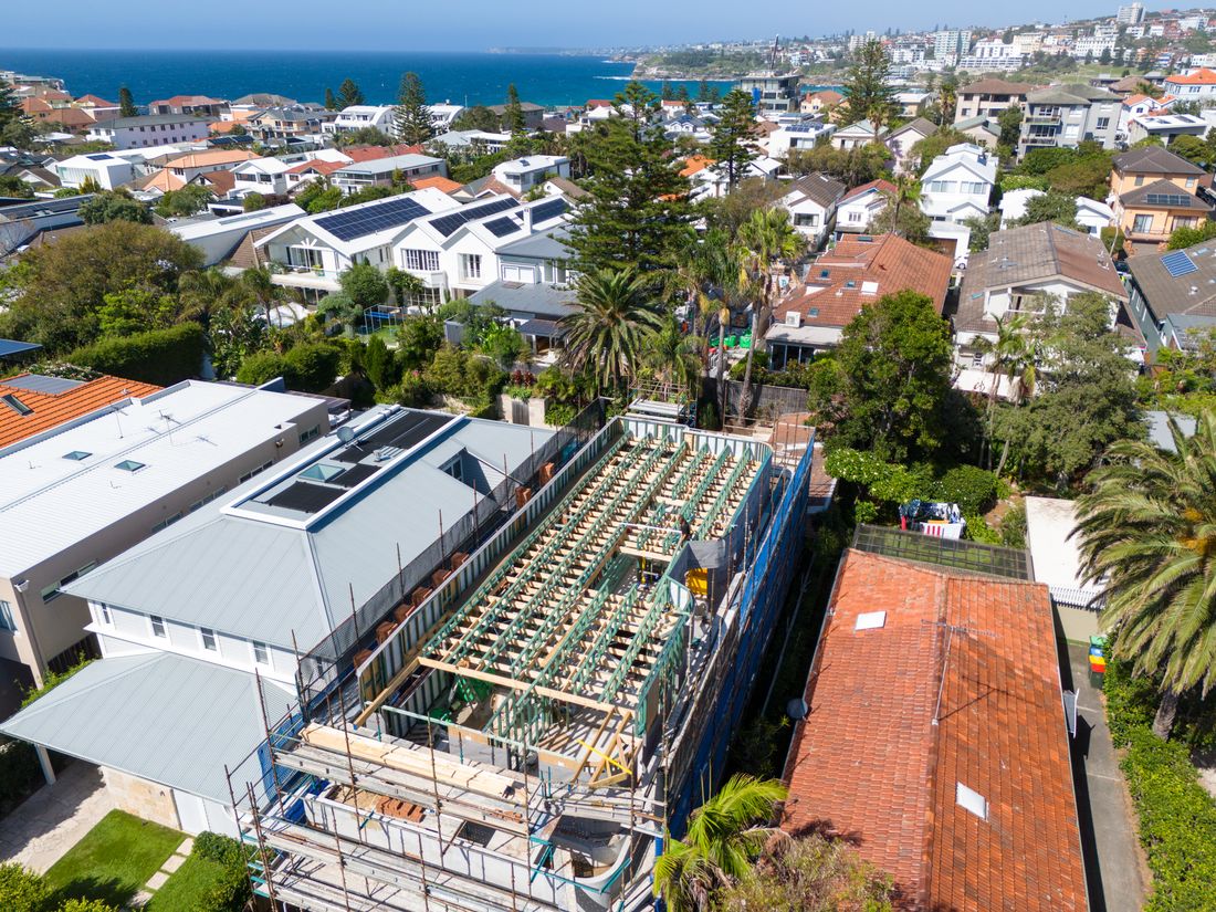 Roof and floor framing under way above the rooftops of North Bondi